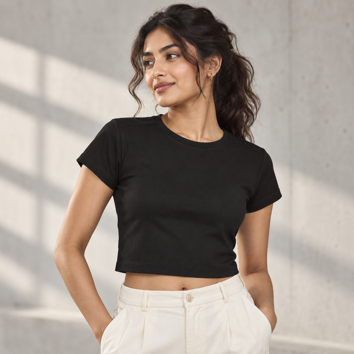 Women’s Fitted Baby Tee — Black on model